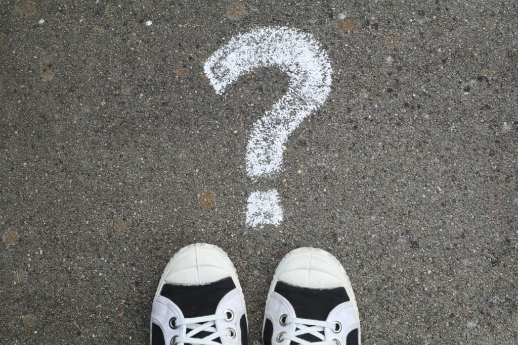 Why Do So Many Young Men Think They Have Low Testosterone? Sneakers on pavement with a chalk question mark, symbolizing curiosity or decisions.